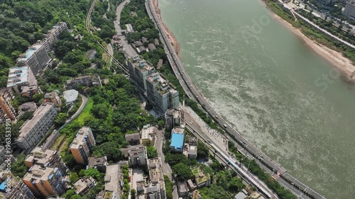 Aerial view of Chongqing Yangtze River waterfront with riverside buildings and green hills