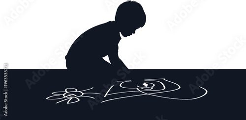 Silhouette child drawing on dark surface with chalk.