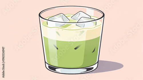 A refreshing glass of iced matcha green tea drink with creamy foam on top on table