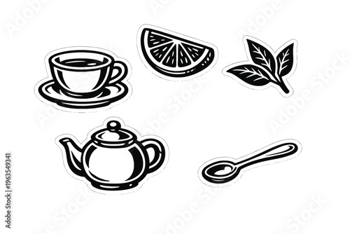 Tea items on a table with a cup, teapot, lemon slice, leaf, and spoon during afternoon tea time at a home setting