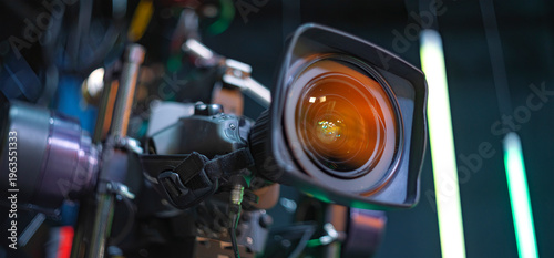 Photos Professional Cinema Camera Lens with Orange Coating in Dark Studio with Copy Spa