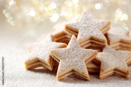 Festive star-shaped sugar cookies with powdered sugar on glittering surface