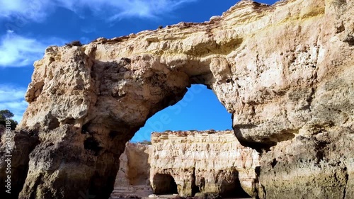 Boat View Through Natural Rock Arch at Ponta da Piedade Algarve Coastline Portugal