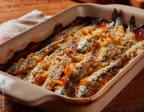 Golden baked anchovies topped with crispy breadcrumbs and fresh herbs. A rustic Italian seafood classic, served warm in a traditional ceramic dish.