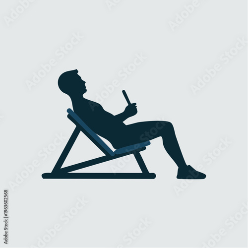 dark blue silhouette of man sitting on beach chair using smartphone