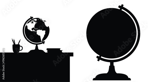 Desk setup with globe books and coffee in dark silhouette