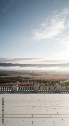Serene morning mist blankets rolling hills and vibrant flower fields viewed from a grand stone terrace with ornate railing