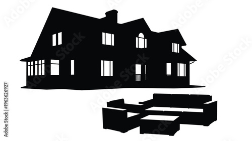 Black silhouette of a large house and patio furniture silhouette