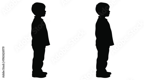 Two young boys standing back to back a striking silhouette