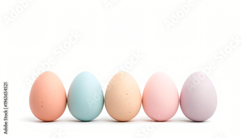 Collection of pastel Easter eggs on a white shelf.