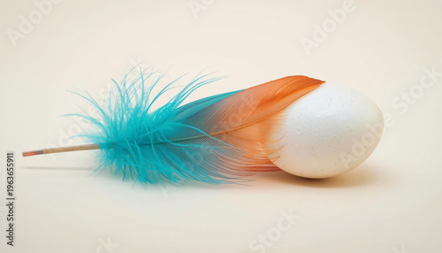 Decorative egg with blue and orange feathers on a soft and light background.