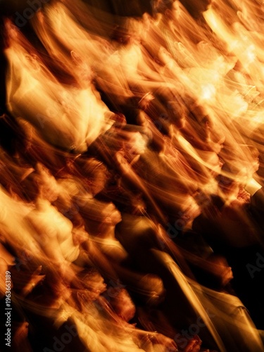 Abstract motion blur of a crowd under warm orange stage light. Dynamic shapes of people create energetic movement and vibrant atmosphere.