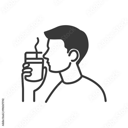 A person smells a hot beverage from a small container