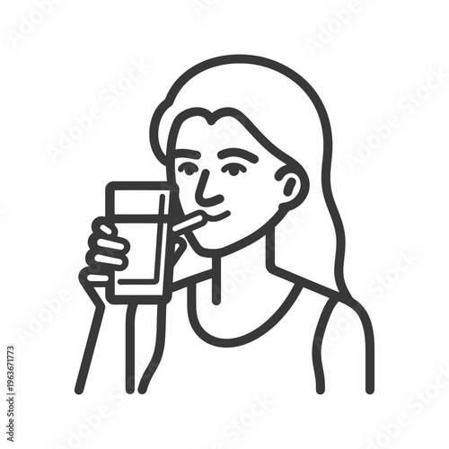 A woman drinks water from a glass using a straw