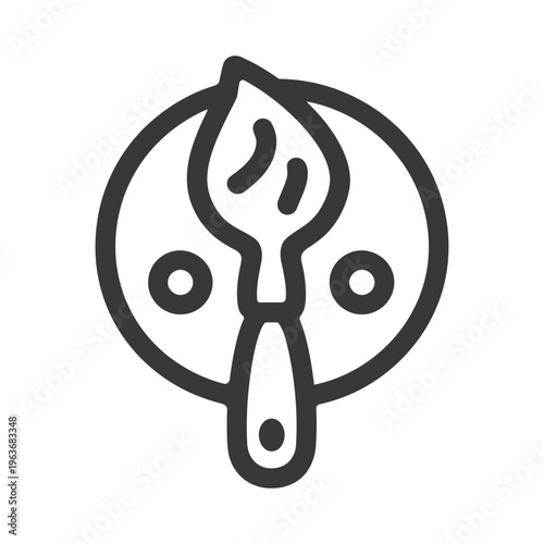 An artistic paintbrush rests on a palette of paints with circles