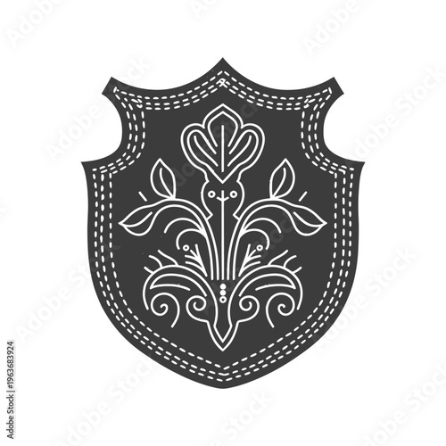 A decorative shield featuring floral and botanical ornamentation design
