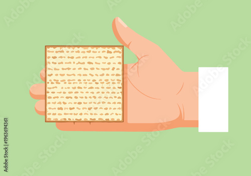 Hand holding piece of matzah, traditional unleavened bread eaten during passover, jewish holiday symbol.