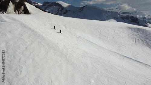 aerial view of skiers skiing in high snowy peak in the pyrenees