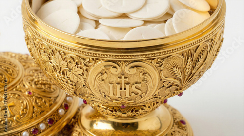 Golden ciborium filling with consecrated communion hosts