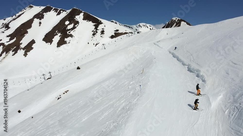 skiers skiing in high snowy peak in the pyrenees