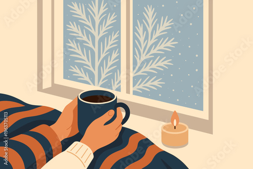 Cozy winter morning with hot drink and candle by the snowy window
