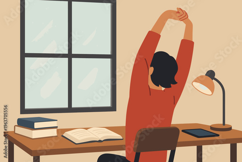 Person stretching arms up while sitting at a desk with books and a lamp