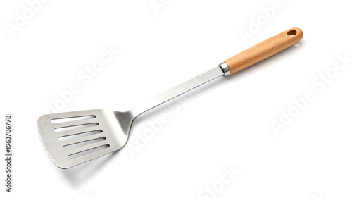 Stainless steel slotted spatula with a natural wooden handle, isolated on white background. Durable kitchen utensil for cooking and flipping.