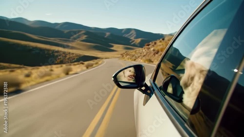 Wallpaper Mural Cinematic tracking video from inside a modern car, a happy cream-colored fluffy dog leaning out, on a sun-drenched open road with winding mountains, golden hour sunlight. Concept of boundless freedom Torontodigital.ca