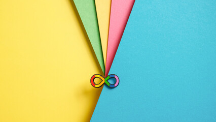 Autism acceptance and awareness concept. Rainbow infinity sign on colorful background