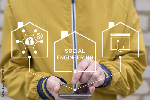Concept of social engineering attack. Person using smartphone and virtual screen sees the text SOCIAL ENGINEERING. Cyber and web security.