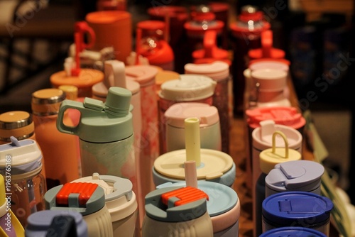 Colorful Reusable Water Bottles And Travel Tumblers With Lids And Straws On Display