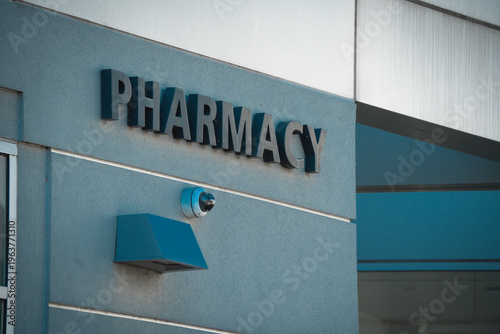 Konstfotografi Exterior view of a modern pharmacy building with prominent signage and security