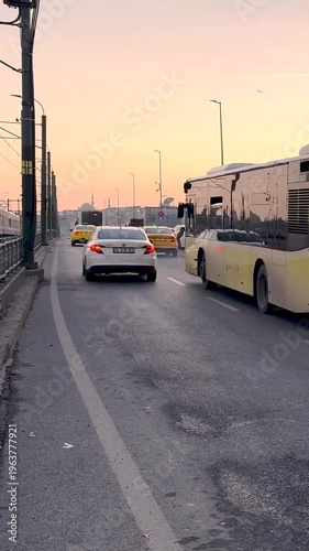 Evening hours. Vehicles are passing in front of the Galata Bridge on the European side of Istanbul.