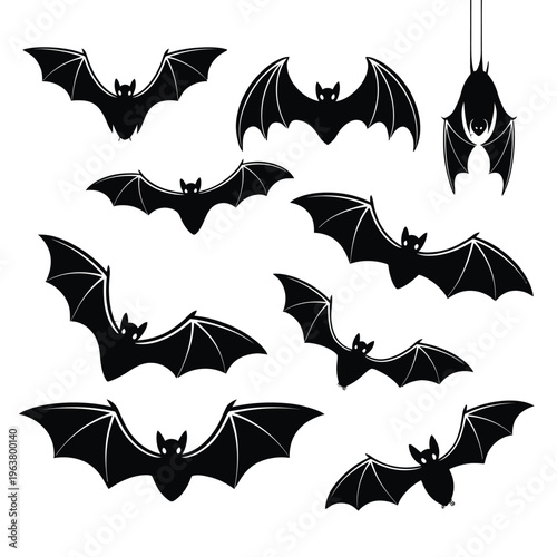 Silhouettes of several black bats in various flying poses against white