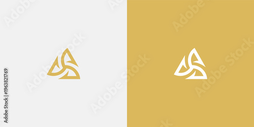 Elegant golden logo design with a triangular shape and intricate details.