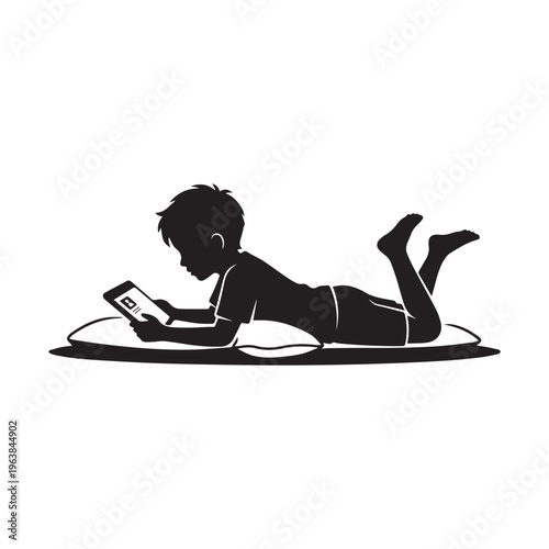 Silhouette of a Little Boy Lying on Floor and Using Tablet Digital Device