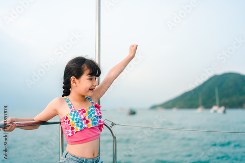 Girl child happy summer vacation sea boat sailboat outdoor travel lineated barbet bird feed nest chick could rest nearby while young girl enjoys summer vacation on sailboat over calm sea