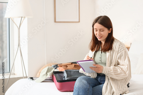 Young woman writing check l...