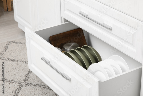 Opened drawer with dishes i...