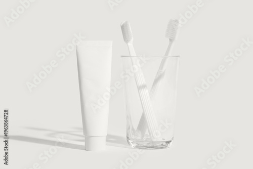 Glass cup with tooth brushe...