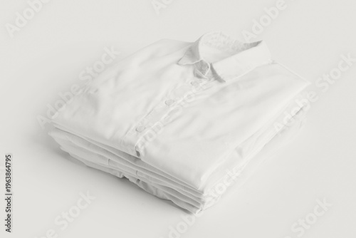Stack of shirts on white ba...