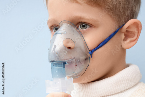 Cute little boy using nebul...