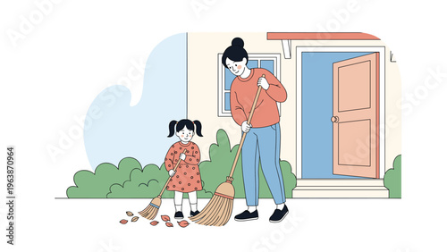 Mother and her little daughter enjoy spending time together while sweeping autumn leaves from the front yard of their house.