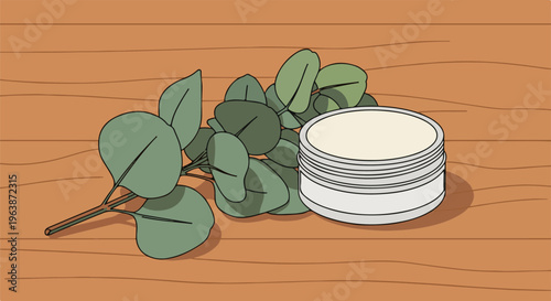 A jar of cream sits next to a branch of green leaves on a wooden surface
