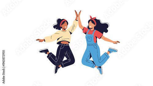 Two cheerful young women jumping high in the air and giving a high-five to celebrate their friendship and success.