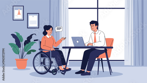 Professional woman in a wheelchair discusses work with a male colleague sitting at a desk with a laptop in an office.