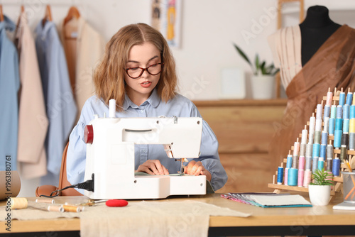 Female tailor sewing clothe...
