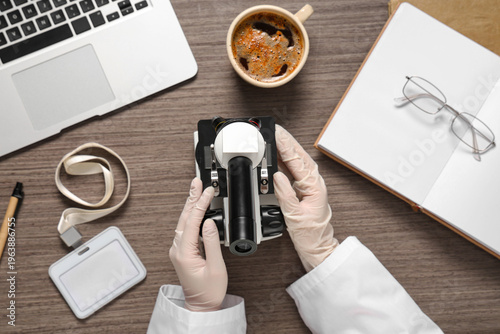Hands of female scientist w...