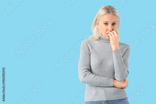 Worried mature woman on blu...