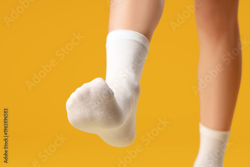 Woman in white socks walkin...